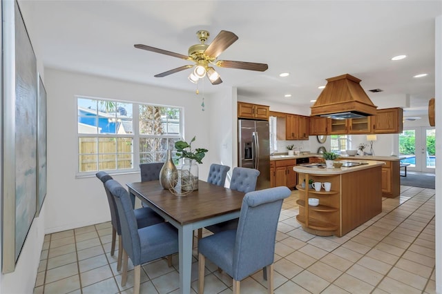 tiled dining area with ceiling fan