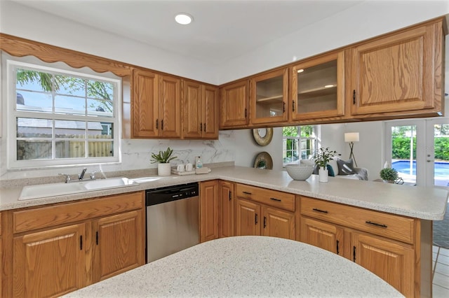 kitchen featuring dishwasher, kitchen peninsula, sink, and a wealth of natural light