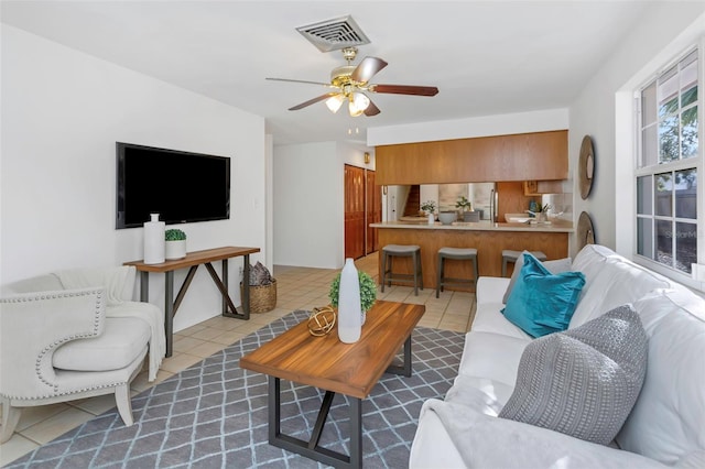 living room with ceiling fan and light tile patterned floors