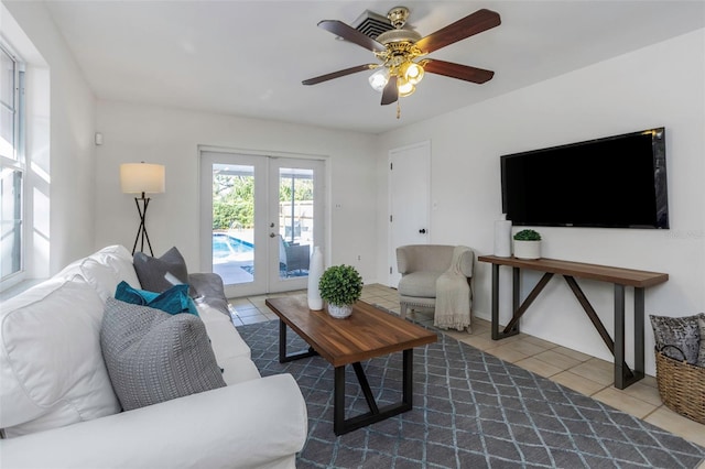 tiled living room featuring french doors and ceiling fan