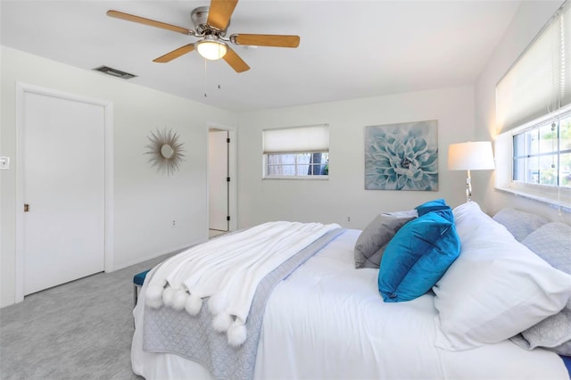 bedroom with ceiling fan and light carpet