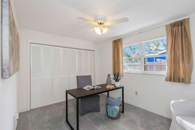 carpeted office space with ceiling fan