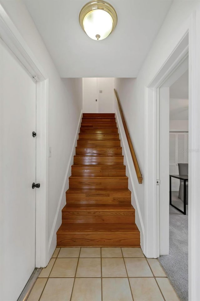 stairs with tile patterned floors