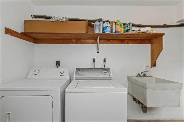 washroom with washing machine and clothes dryer and sink