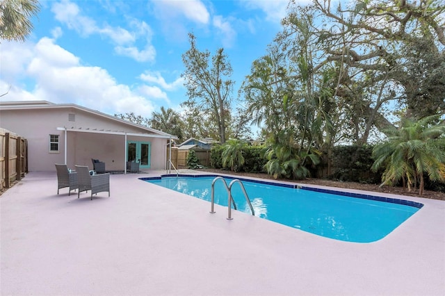 view of swimming pool with a patio area