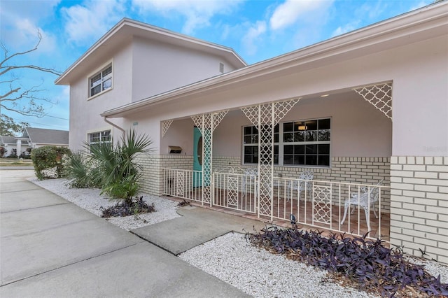 view of exterior entry with a porch