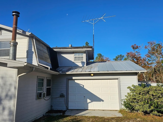 exterior space with cooling unit and a garage