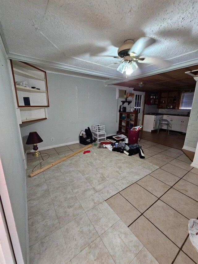 exercise room featuring light tile patterned flooring and a textured ceiling