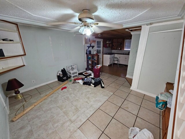 exercise room with light tile patterned floors, a textured ceiling, and ceiling fan