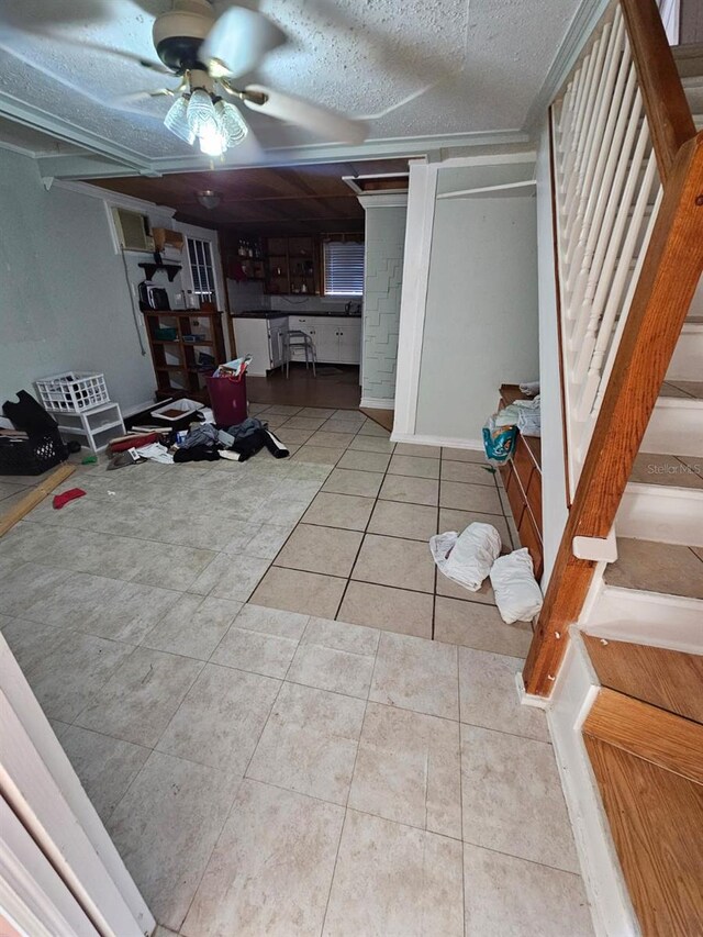 interior space with ceiling fan and a textured ceiling