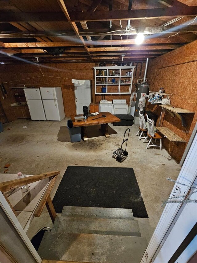 basement with white fridge, water heater, and washing machine and clothes dryer