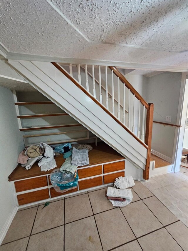 stairs featuring tile patterned flooring