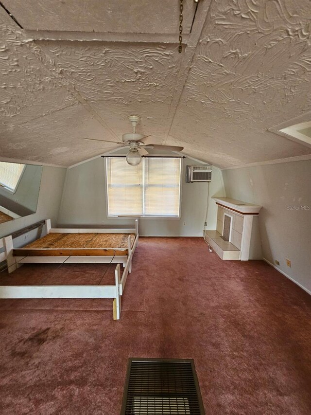 bonus room featuring a wall mounted AC, ceiling fan, carpet, and vaulted ceiling