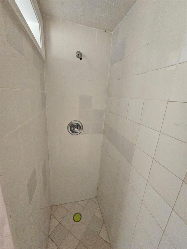 bathroom with a tile shower