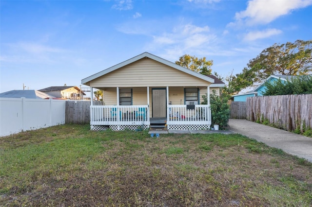 bungalow-style house featuring a front lawn and a porch