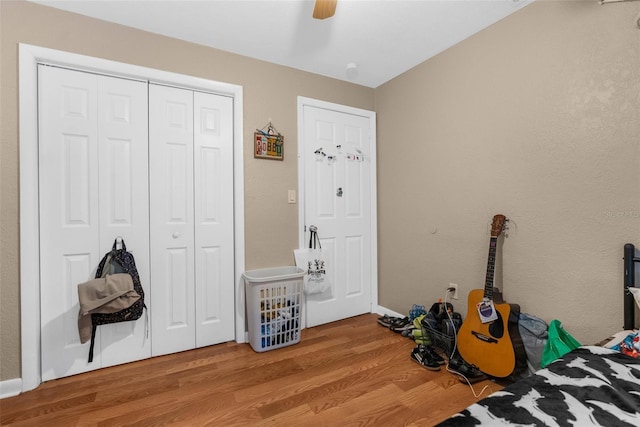 bedroom featuring hardwood / wood-style floors, a closet, and ceiling fan