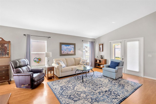 living room with light hardwood / wood-style flooring and lofted ceiling