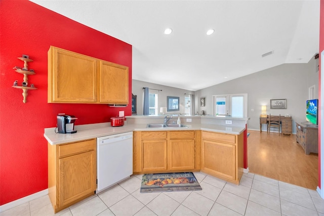 kitchen with lofted ceiling, white dishwasher, sink, light tile patterned floors, and kitchen peninsula