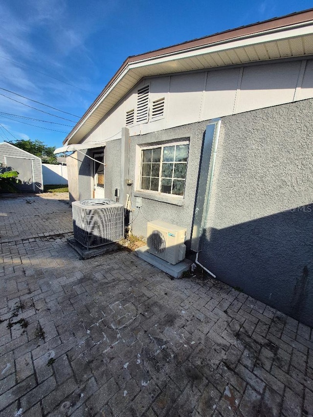 exterior space with a patio area, ac unit, and central AC