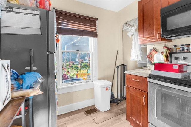 kitchen with light wood-type flooring and stainless steel electric range