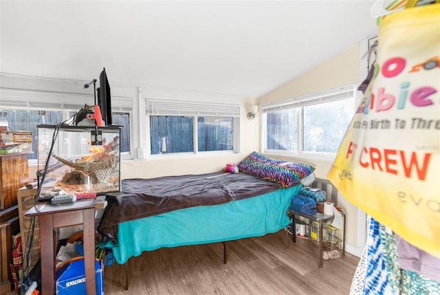 bedroom featuring hardwood / wood-style flooring and lofted ceiling