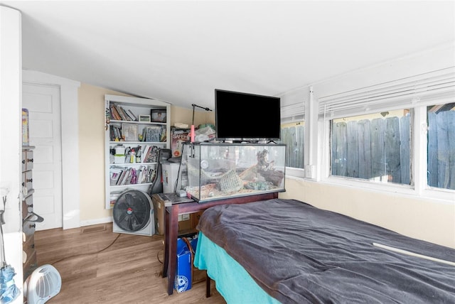 bedroom featuring lofted ceiling and hardwood / wood-style flooring