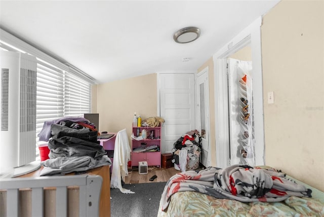 bedroom featuring hardwood / wood-style flooring and vaulted ceiling