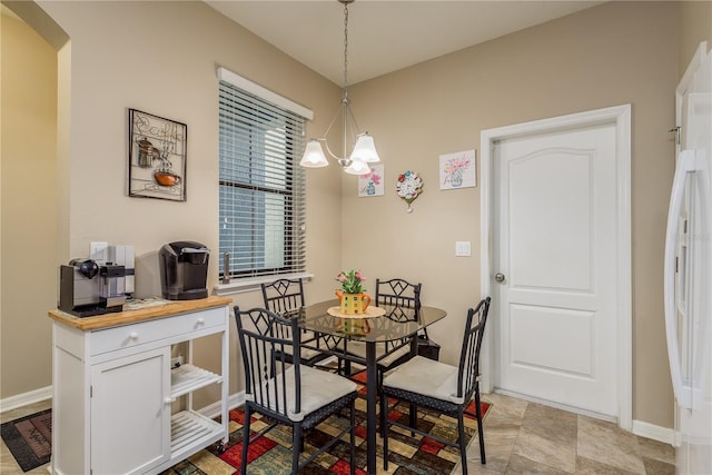 dining area featuring an inviting chandelier