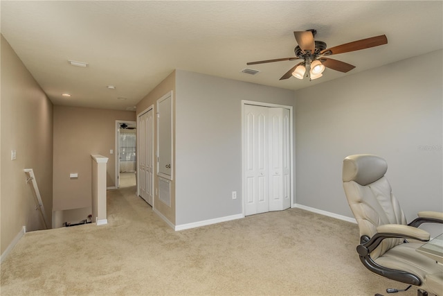 carpeted home office with ceiling fan