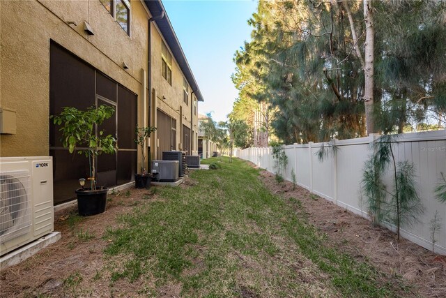 view of yard with ac unit and central AC unit