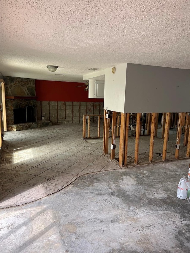 basement featuring a textured ceiling