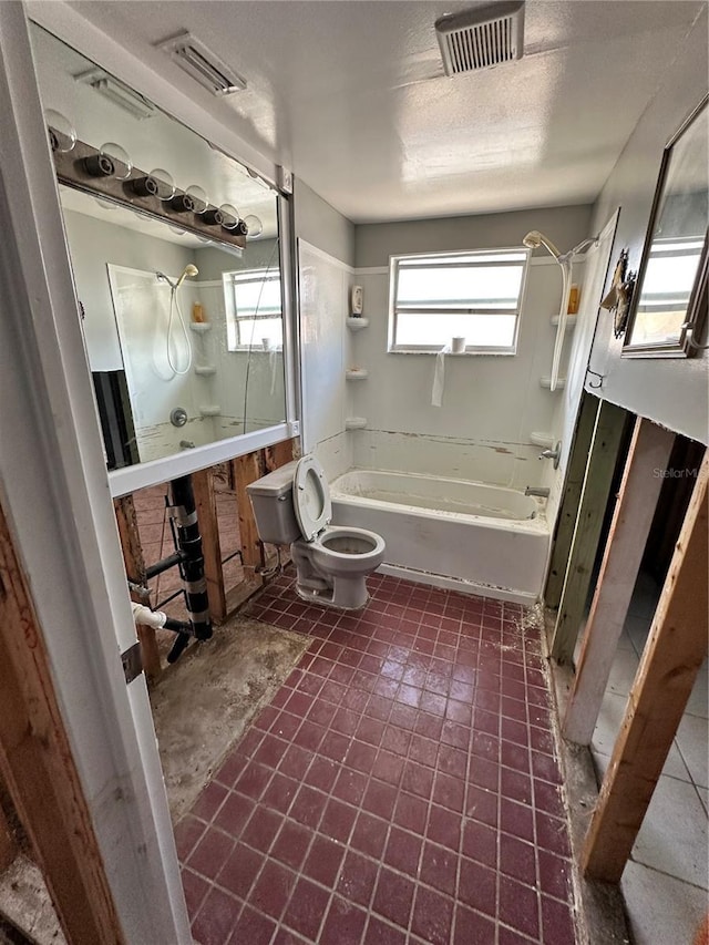 bathroom featuring toilet and a textured ceiling