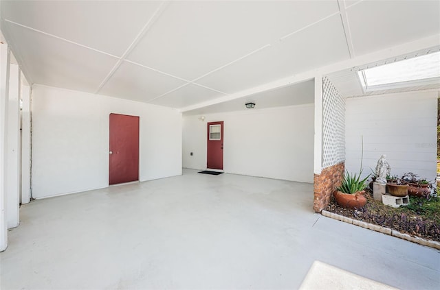 interior space with concrete floors and a skylight