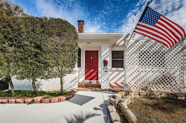 entrance to property featuring a chimney