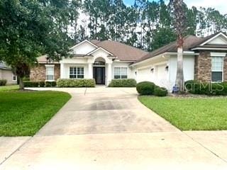 view of front of house featuring a garage and a front lawn