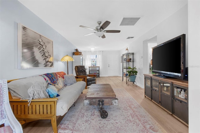 living room featuring ceiling fan and light hardwood / wood-style flooring