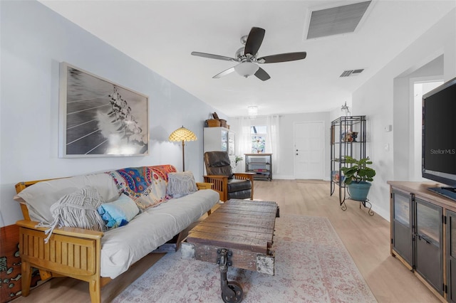 living room featuring ceiling fan and light hardwood / wood-style flooring