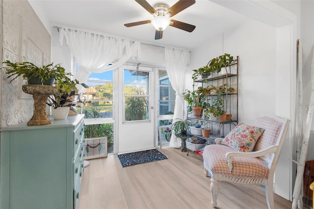 sunroom featuring ceiling fan