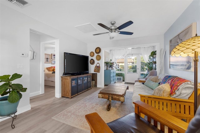 living room featuring ceiling fan and light hardwood / wood-style floors