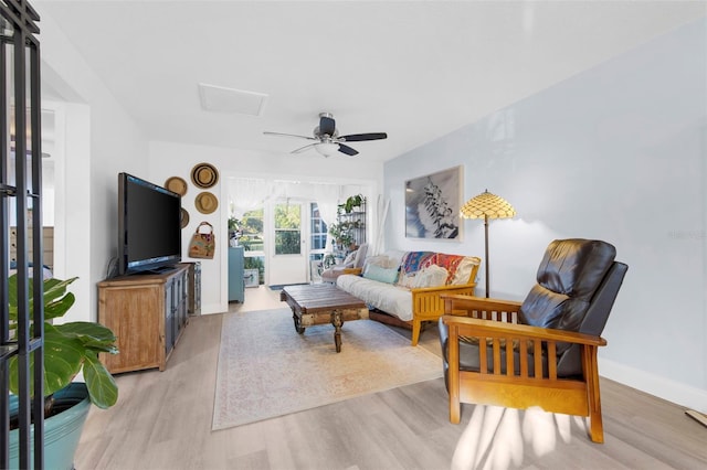 living room with ceiling fan and light wood-type flooring