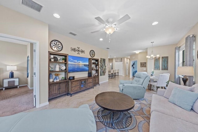 carpeted living room featuring ceiling fan with notable chandelier