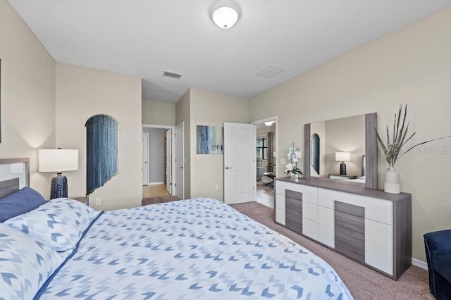 bedroom featuring light colored carpet