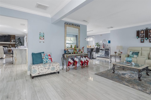 living room with a stone fireplace, crown molding, beamed ceiling, and light hardwood / wood-style floors