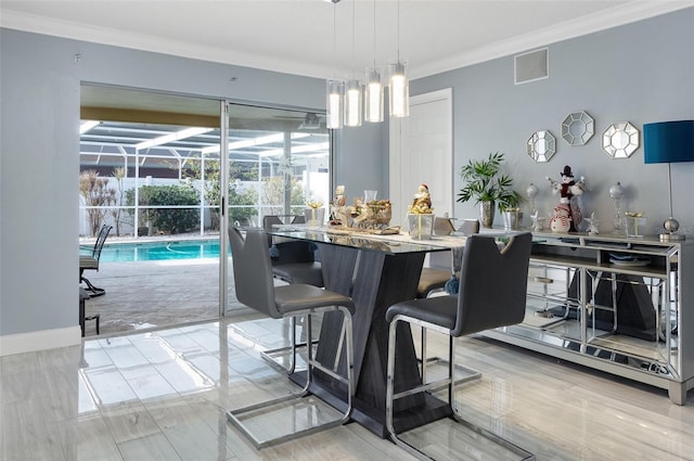 dining space with ornamental molding