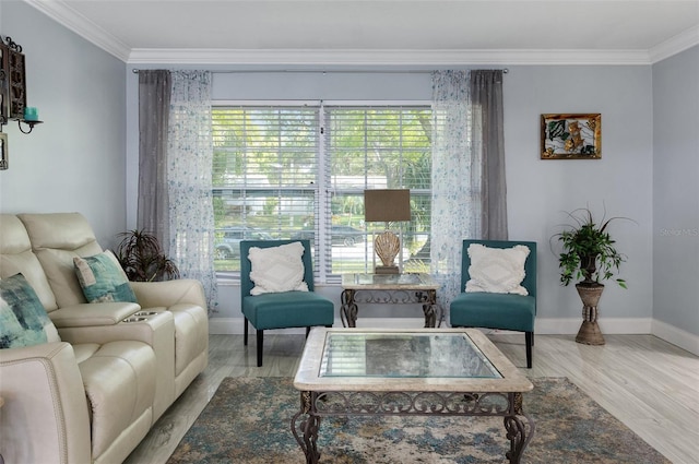 living area with crown molding, wood finished floors, and baseboards
