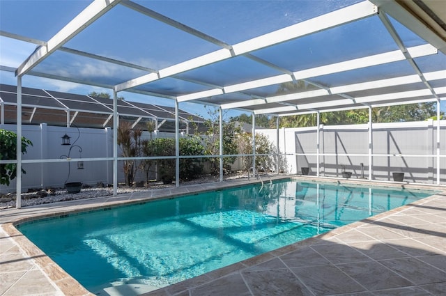 view of pool with a patio area, a fenced backyard, a fenced in pool, and a lanai