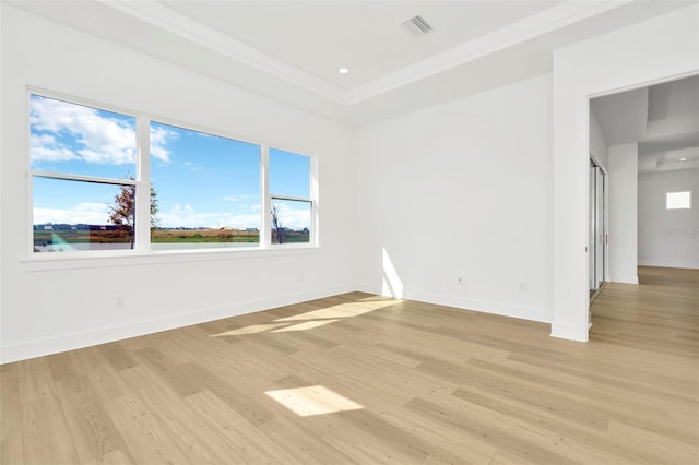 empty room with ornamental molding and light wood-type flooring