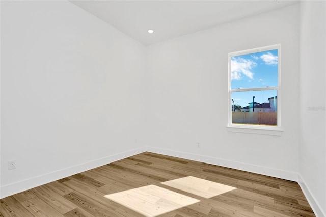 unfurnished room with light hardwood / wood-style floors