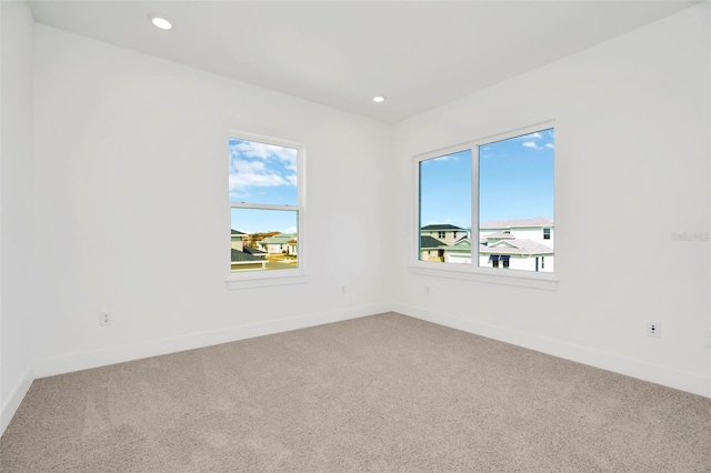 carpeted empty room featuring plenty of natural light