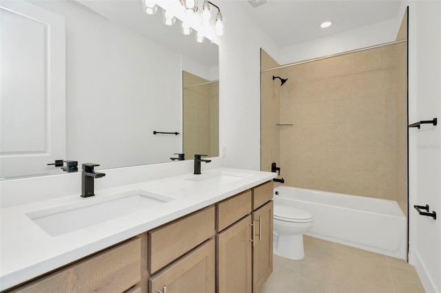 full bathroom featuring tile patterned flooring, tiled shower / bath combo, toilet, and vanity